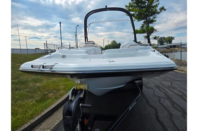 Slide: The Image of 2020 Hurricane SunDeck Sport 202 IO boat on trailer, parked outdoors. - 6