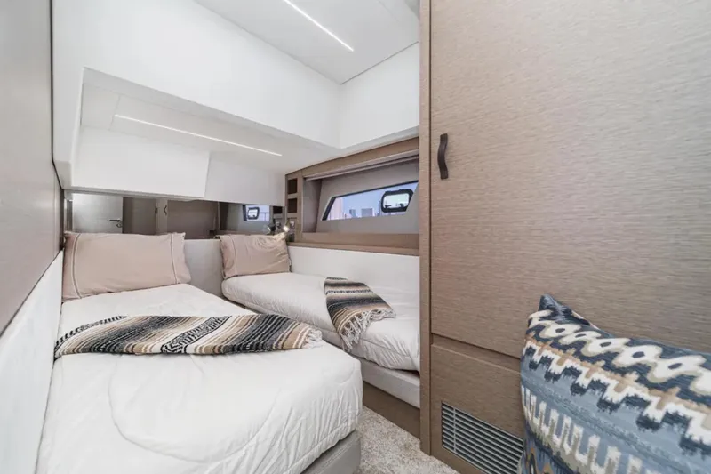 Slide: The Image of Luxurious 2019 Prestige 520 yacht cabin with twin beds and modern decor. - 20