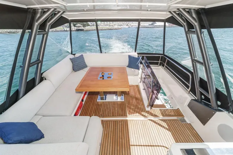 Slide: The Image of Luxurious 2019 Prestige 520 yacht interior with elegant seating and wooden table on open water. - 26
