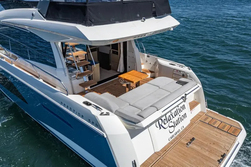 Slide: The Image of Luxury 2019 Prestige 520 yacht named "Relaxation Station" on open water. - 3