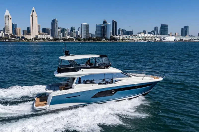 Slide: The Image of 2019 Prestige 520 yacht cruising near a city skyline on a sunny day. - 31