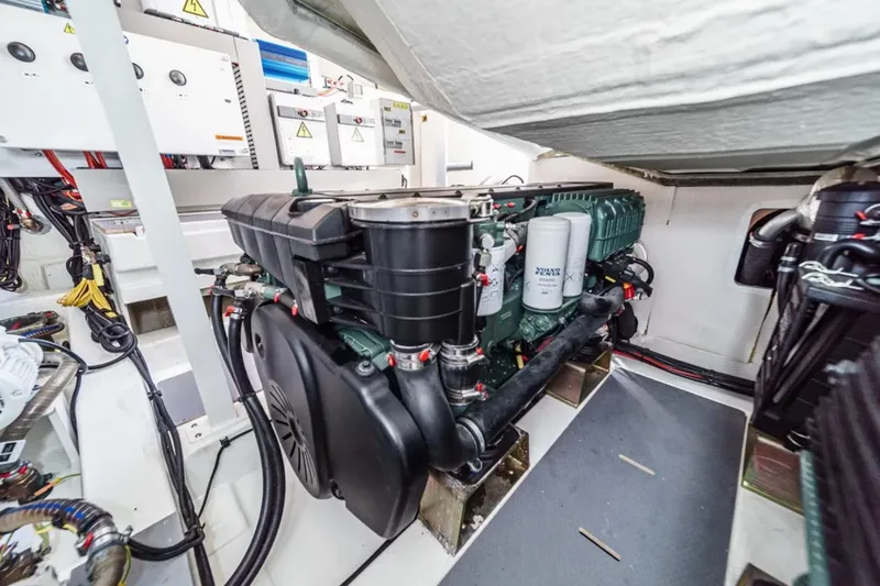 Slide: The Image of Engine room of a 2019 Prestige 520 yacht, showcasing mechanical components and wiring. - 38