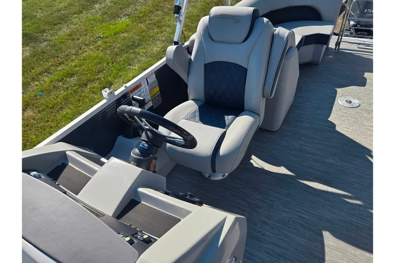 Slide: The Image of 2022 Bennington L 22 L-Bench boat interior with steering wheel and luxurious seating. - 13