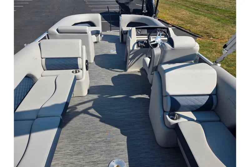 Slide: The Image of 2022 Bennington L 22 L-Bench pontoon boat interior with plush seating and steering console. - 18