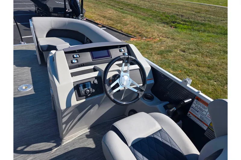 Slide: The Image of 2022 Bennington L 22 L-Bench boat interior with steering wheel and seating. - 19