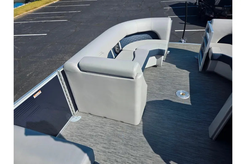 Slide: The Image of 2022 Bennington L 22 L-Bench pontoon boat interior with gray seating and flooring. - 20