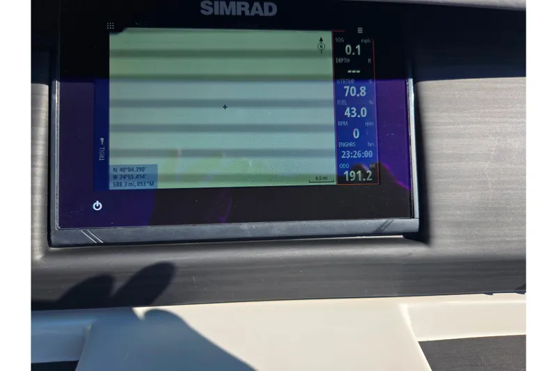 Slide: The Image of Simrad display on 2022 Bennington L 22 L-Bench showing navigation and engine data. - 23