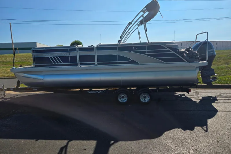 Slide: The Image of 2022 Bennington L 22 L-Bench pontoon boat on trailer, side view. - 4