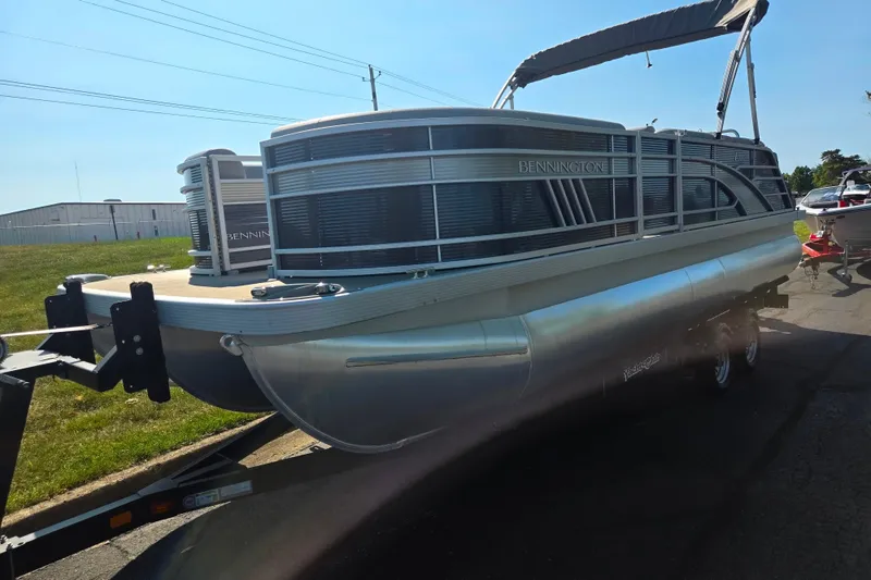 Slide: The Image of 2022 Bennington L 22 L-Bench pontoon boat on trailer, sunny day. - 5
