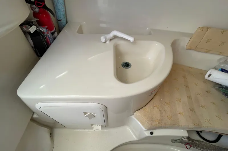 Slide: The Image of 2007 Wellcraft 252 Coastal boat interior with sink and storage compartment. - 14