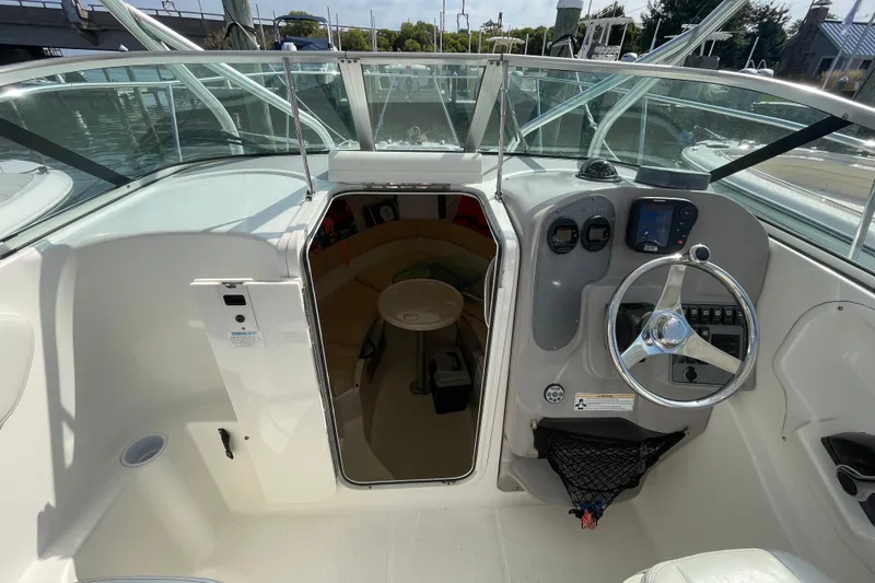 Slide: The Image of 2007 Wellcraft 252 Coastal boat interior with steering wheel and cabin entrance. - 15