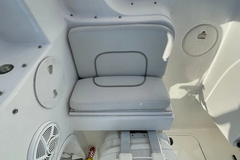 Slide: The Image of 2007 Wellcraft 252 Coastal boat interior with cushioned seating and storage compartments. - 22