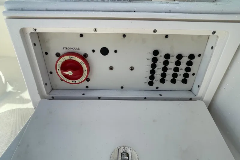 Slide: The Image of Control panel of a 2007 Wellcraft 252 Coastal boat with switches and a red dial. - 26