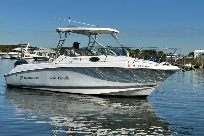 Slide: The Image of 2007 Wellcraft 252 Coastal boat named "Miss Camille" on calm water. - 3