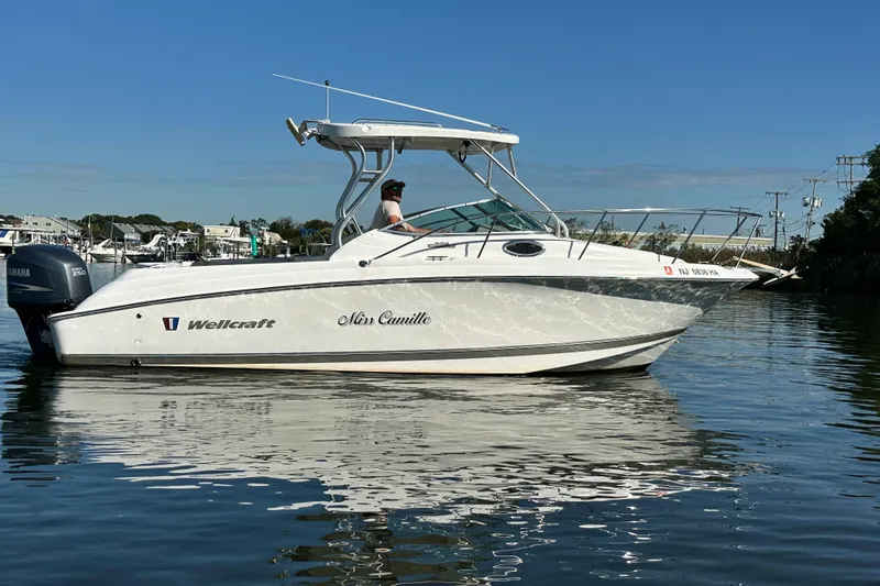 Slide: The Image of 2007 Wellcraft 252 Coastal boat on calm water, side view, clear sky background. - 4