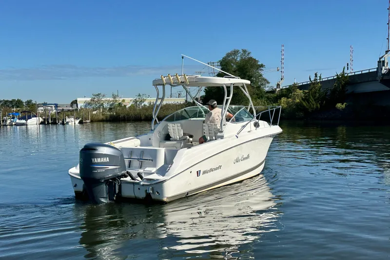 Slide: The Image of 2007 Wellcraft 252 Coastal boat on calm water with Yamaha engine. - 5