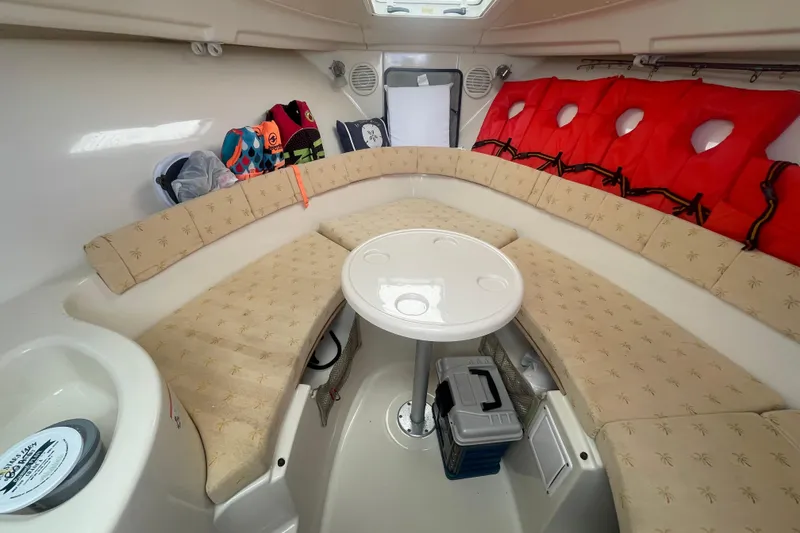 Slide: The Image of Interior of 2007 Wellcraft 252 Coastal boat with seating, table, and life jackets. - 8