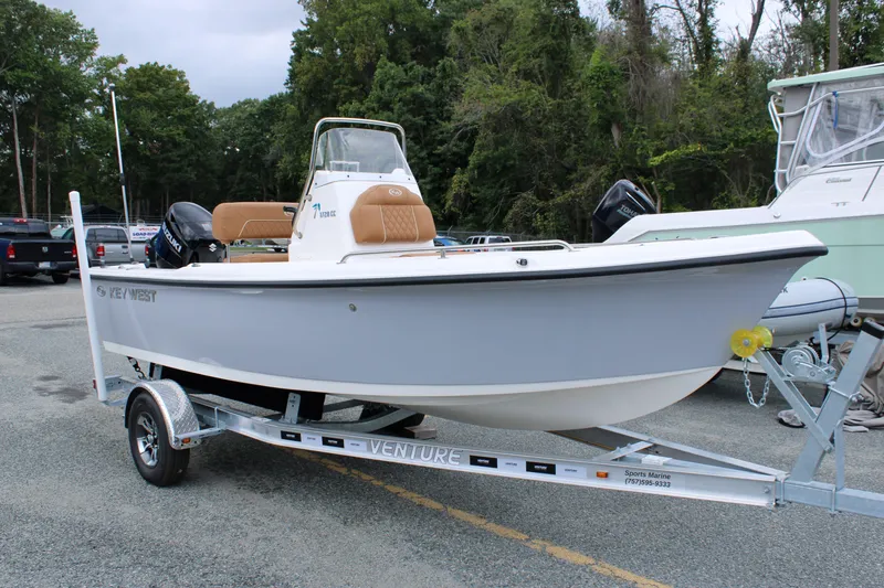 The Image of 2026 Key West 1720 Center Console boat on trailer, parked outdoors. - 0