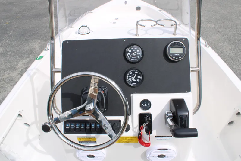 Slide: The Image of 2026 Key West 1720 Center Console boat dashboard with steering wheel and gauges. - 10