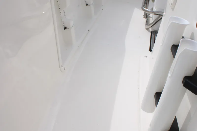 Slide: The Image of 2026 Key West 1720 Center Console boat interior, featuring sleek white design and rod holders. - 18