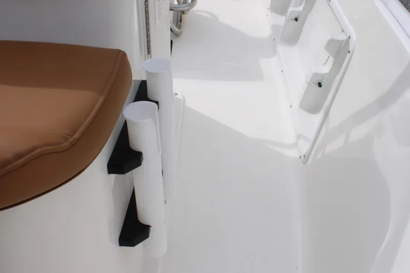Slide: The Image of 2026 Key West 1720 Center Console boat interior with tan seating and rod holders. - 19