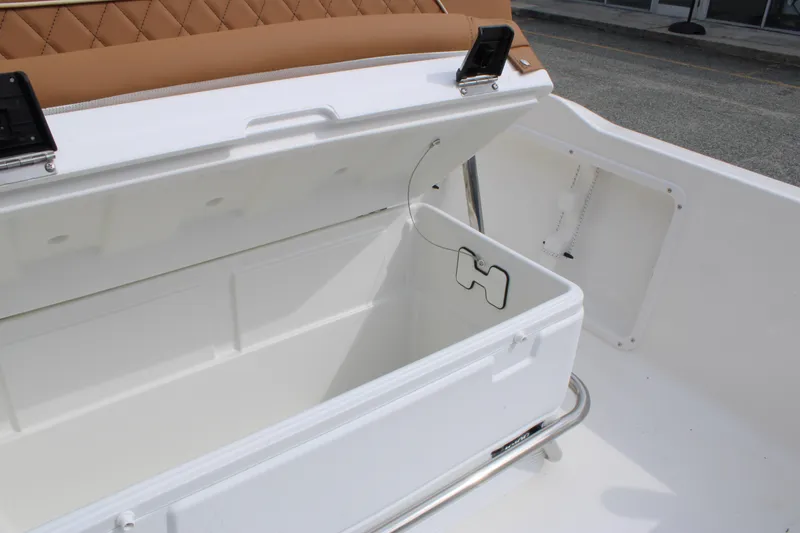 Slide: The Image of 2026 Key West 1720 Center Console boat storage compartment with open lid. - 21