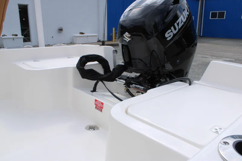 Slide: The Image of 2026 Key West 1720 Center Console boat with Suzuki outboard motor in a marina setting. - 24