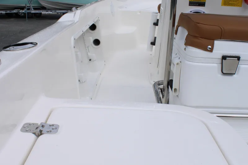 Slide: The Image of 2026 Key West 1720 Center Console boat interior with white seating and storage. - 25