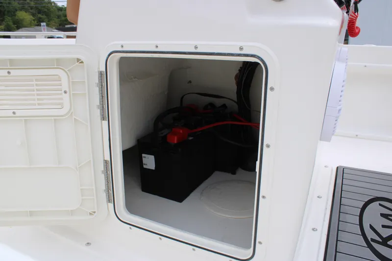 Slide: The Image of Open storage compartment on 2026 Key West 1720 Center Console boat, showing battery inside. - 32