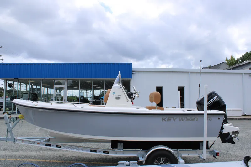 Slide: The Image of 2026 Key West 1720 Center Console boat on trailer, parked outside dealership. - 5
