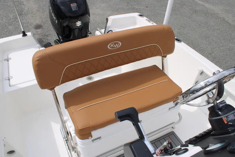 Slide: The Image of 2026 Key West 1720 Center Console boat interior with tan seating and steering wheel. - 9