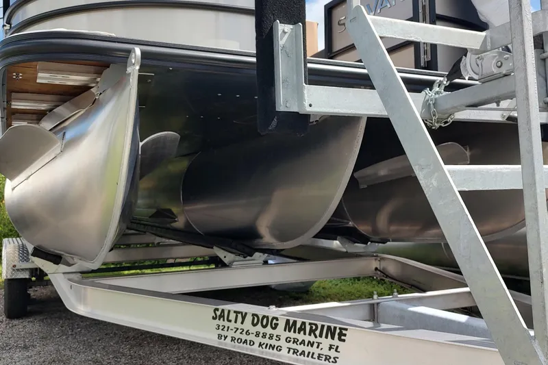 Slide: The Image of 2026 Sylvan Mirage X3 Party Fish pontoon boat on trailer, close-up view. - 10