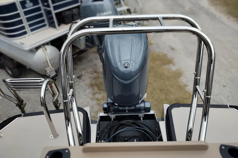 Slide: The Image of 2026 Sylvan Mirage X3 Party Fish boat with Yamaha outboard motor, rear view. - 21