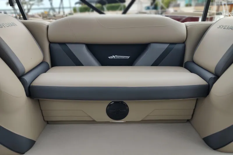 Slide: The Image of 2026 Sylvan Mirage X3 Party Fish boat interior seating, beige and gray upholstery. - 23
