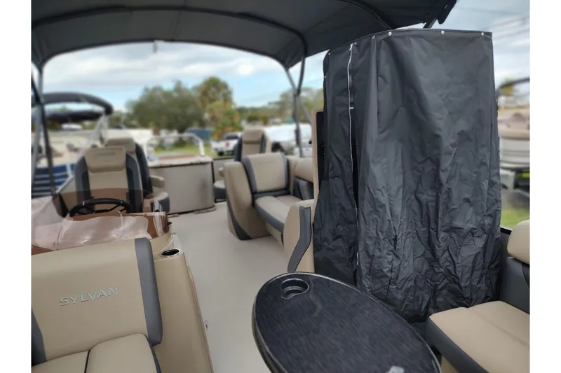 Slide: The Image of 2026 Sylvan Mirage X3 Party Fish boat interior with seating and covered area. - 24