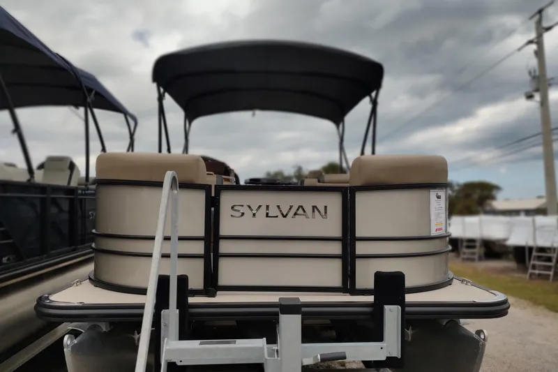 Slide: The Image of 2026 Sylvan Mirage X3 Party Fish pontoon boat, rear view, overcast sky. - 29