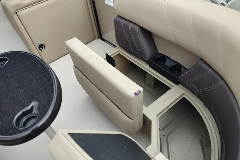 Slide: The Image of 2026 Sylvan Mirage X3 Party Fish boat interior with storage and cup holders. - 30