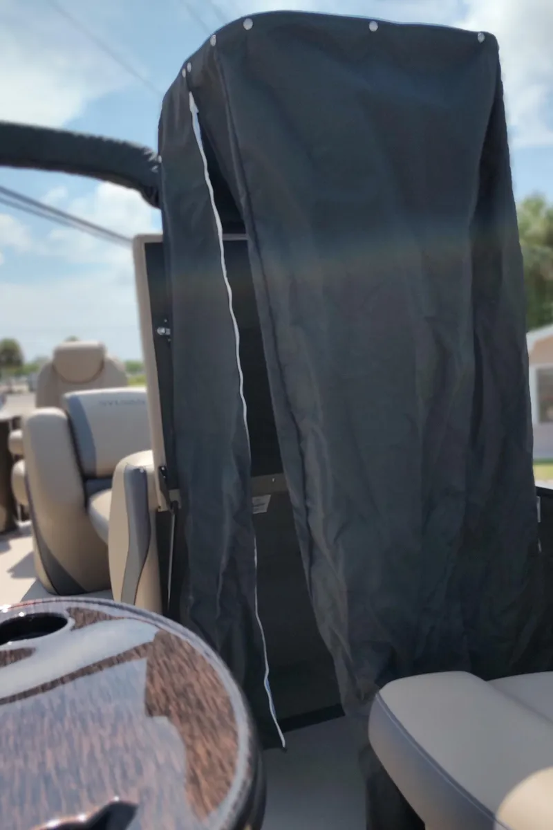 Slide: The Image of 2026 Sylvan Mirage X3 Party Fish pontoon boat on trailer, close-up view. - 8