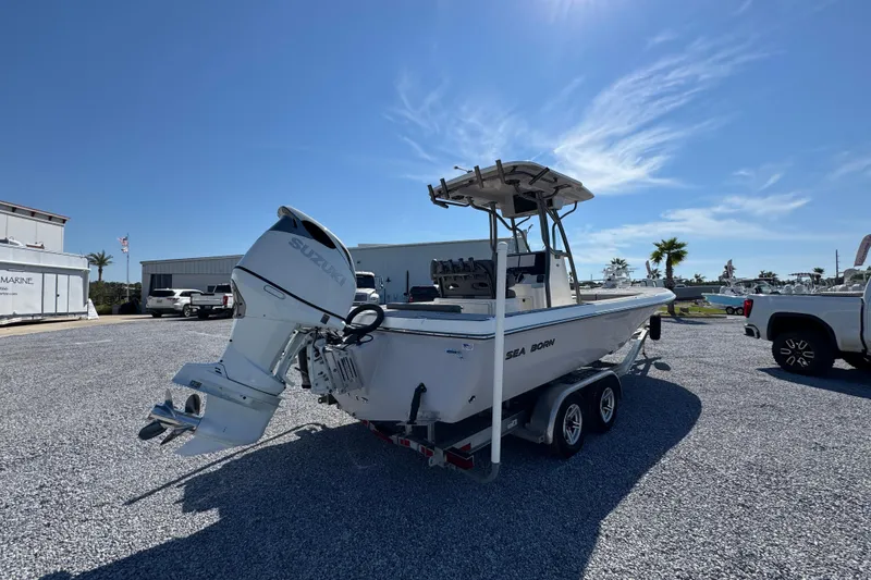 Slide: The Image of 2022 Sea Born FX25 Bay boat on trailer with Suzuki outboard motor. - 11
