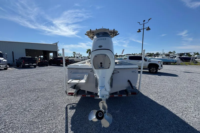 Slide: The Image of 2022 Sea Born FX25 Bay boat with powerful outboard motor in a dealership lot. - 13