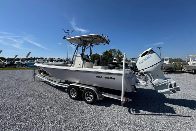 Slide: The Image of 2022 Sea Born FX25 Bay boat with Suzuki engine on trailer under clear blue sky. - 16