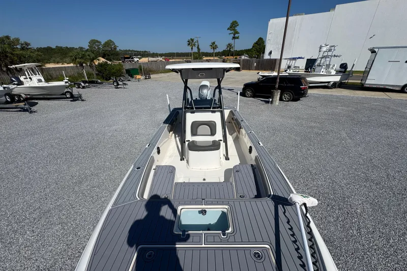 Slide: The Image of 2022 Sea Born FX25 Bay boat in a parking lot, showcasing deck and seating. - 22