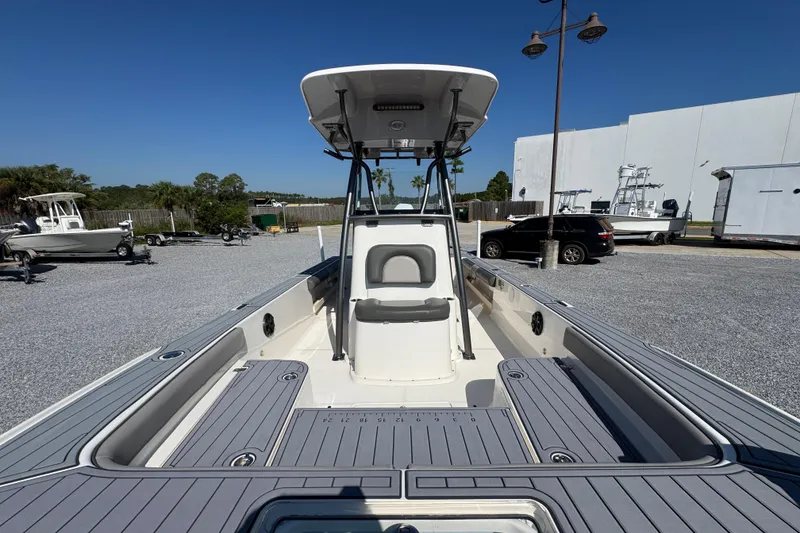 Slide: The Image of 2022 Sea Born FX25 Bay boat in a parking lot, showcasing deck and seating. - 23