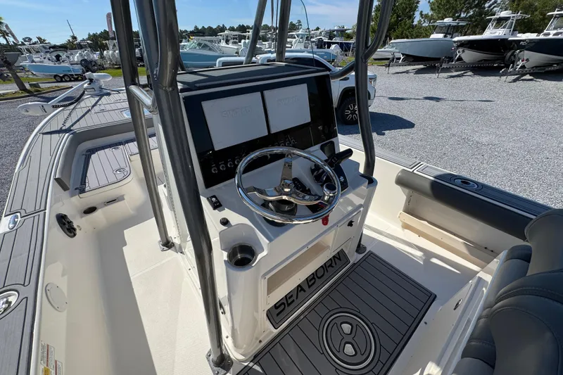 Slide: The Image of 2022 Sea Born FX25 Bay boat interior with steering console and seating. - 29
