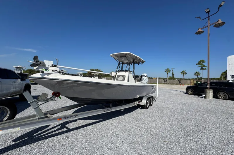 Slide: The Image of 2022 Sea Born FX25 Bay boat on trailer in sunny parking lot. - 3