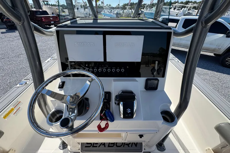 Slide: The Image of 2022 Sea Born FX25 Bay boat dashboard with steering wheel and Simrad displays. - 30