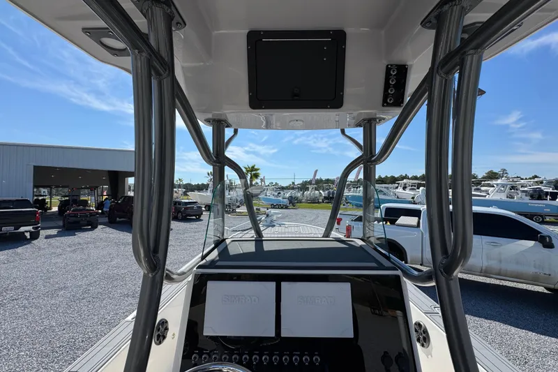 Slide: The Image of 2022 Sea Born FX25 Bay boat interior with navigation system, parked in a marina. - 31