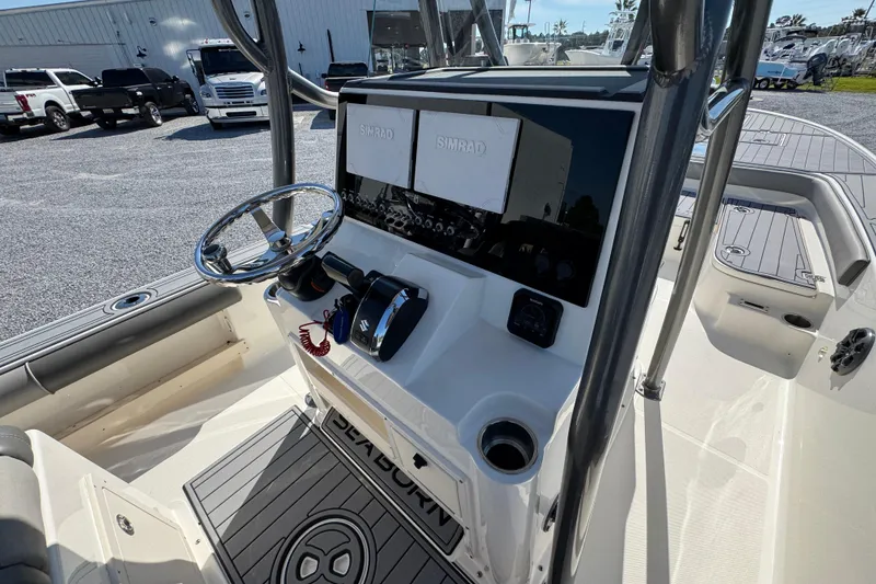 Slide: The Image of 2022 Sea Born FX25 Bay boat console with steering wheel and Simrad displays. - 32