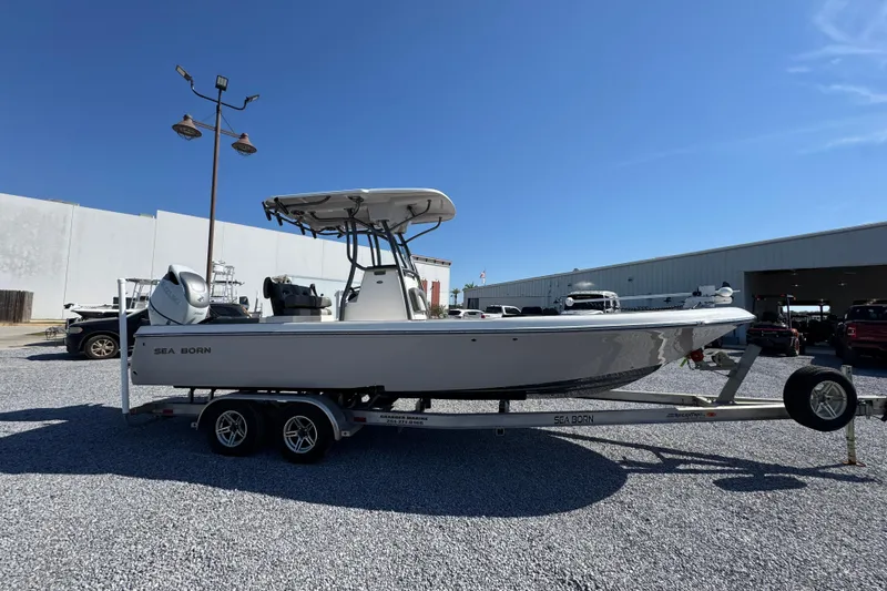 Slide: The Image of 2022 Sea Born FX25 Bay boat on trailer in outdoor dealership lot. - 8