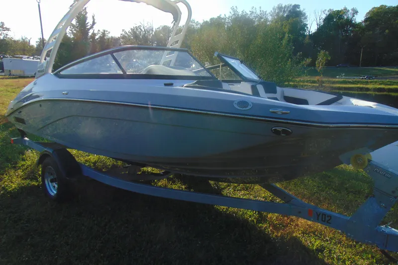 Slide: The Image of 2026 Yamaha Boats 195S on trailer in grassy outdoor setting. - 13